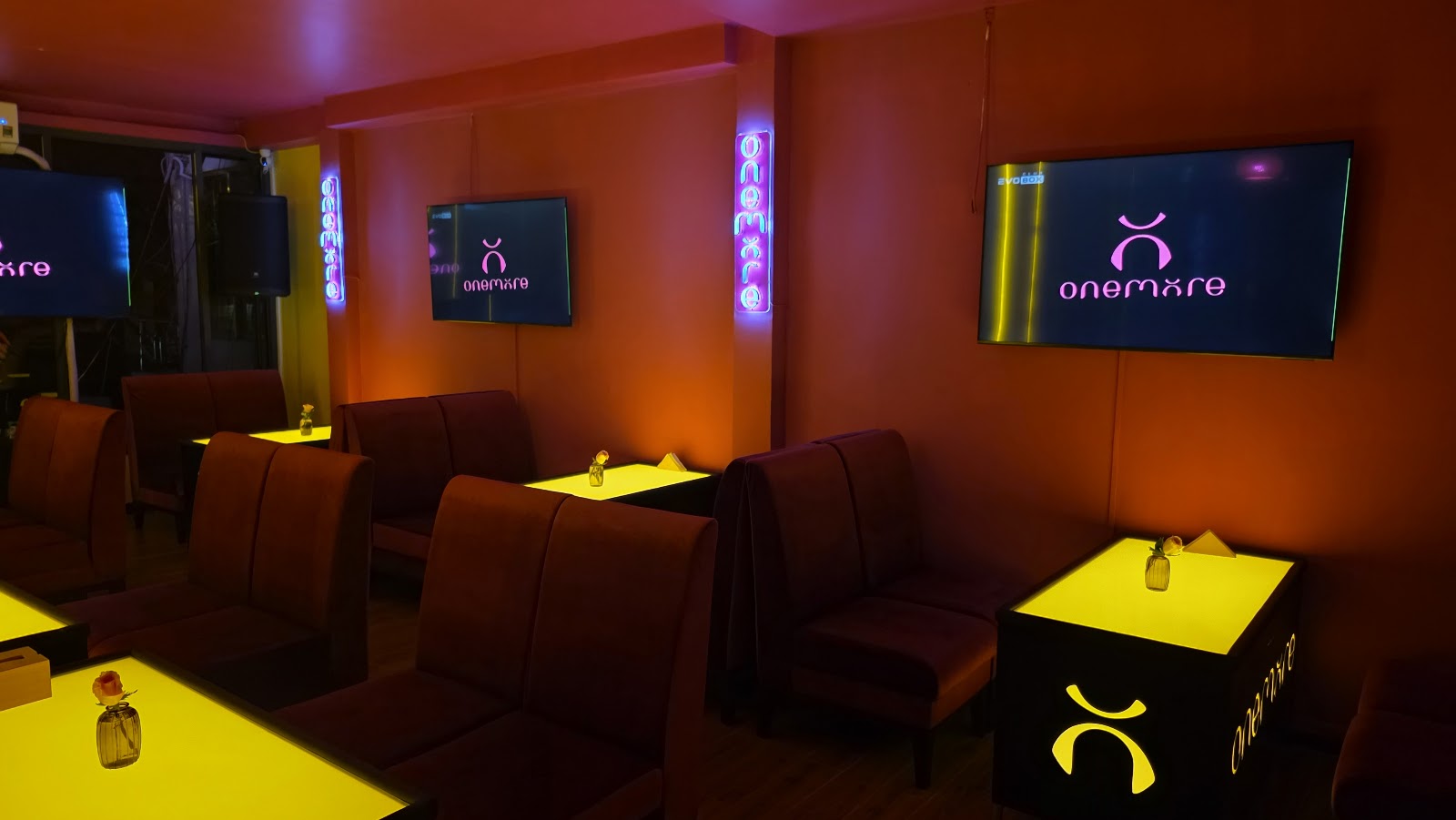 Lounge seating, tables and screens inside OneMore
